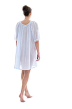 Load image into Gallery viewer, Azure Short (98cm) 3/4 Length Sleeve nightgown. Gorgeous 100% Guipure Cotton Lace at the gently rounded neckline and sleeve edge. Flared skirt for ease of movement when sleeping. Made in Germany from the finest pure cotton mousseline, Celestine nightdresses are diaphanous, offering perfect sleep without heaviness.
Celestine nightwear, dressing gowns and short robes drop from the shoulder, therefore one size fits all.
Composition: 100% Pure Swiss Cotton, 100% Guipure Cotton Lace
Machine Washable.