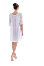 Load image into Gallery viewer, White Short (98cm) 3/4 Length Sleeve nightgown. Gorgeous 100% Guipure Cotton Lace at the gently rounded neckline and sleeve edge. Flared skirt for ease of movement when sleeping. Made in Germany from the finest pure cotton mousseline, Celestine nightdresses are diaphanous, offering perfect sleep without heaviness.
Celestine nightwear, dressing gowns and short robes drop from the shoulder, therefore one size fits all.
Composition: 100% Pure Swiss Cotton, 100% Guipure Cotton Lace
Machine Washable.