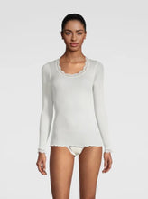 Load image into Gallery viewer, Ivory. Long Sleeve style delicate fine ribbed knit fabric in pure silk organza with the most elegant and feminine French leavers lace at the neckline and cuff. The lace is certified and numbered as true “Dentelle de Calais®”. Super-soft touch with no side seams, the construction is for the ultimate in comfort. Featuring a gently scooped neckline this top allows for a multiple of uses, as underwear or outerwear. 100% Silk All Oscalito Silk is certified GOTs. Machine washable