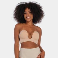 Load image into Gallery viewer, A woman modeling a nude beige lingerie set consisting of a strapless bandeau top with molded cups against a solid light gray background.