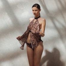 Load image into Gallery viewer, This is a stunning Babydoll set in floaty chiffon. The top is attached at the neck with a jewelled detail. The back is completely open. The light chiffon fabric has a pattern of map scenes of old Paris, always the city of love!
The briefs have a frilled edge and are bikini style.
The top is one size, the briefs are sized.
Made in France.