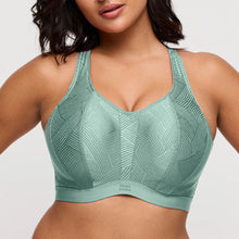 Load image into Gallery viewer, Green sports bra with geometric pattern worn by a model on a light gray background