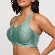 Load image into Gallery viewer, Woman wearing a green sports bra against a plain background