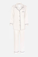 Load image into Gallery viewer, Our own classic pure silk 'men's style' pyjamas. They are made from 19 mm 100% pure heavyweight Silk Satin. One seam on the leg for extra comfort. Mother-of-pearl buttons, elastic waist the trousers. Perfect for sleeping and loungewear. Available in two colourways: Ivory/Navy Piping.