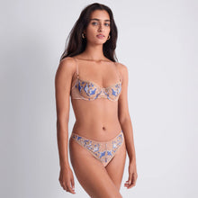 Load image into Gallery viewer, A woman poses confidently in a beige and blue embroidered lingerie set against a neutral background, conveying elegance and modern fashion.