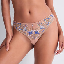 Load image into Gallery viewer, Close-up of a person wearing nude mesh panties with intricate blue and beige geometric French embroidery. The background is a soft gray, conveying elegance and style.