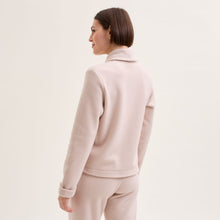 Load image into Gallery viewer, Sand. Soft fleece wrapover long sleeved bedjacket. It closes with a single Corozo button. The shawl collar and curved front detail add the final touches of style to this soft, light and cosy bedjacket. Made in Portugal. Available in Azur Blue Composition: 70% Polyester, 30% Viscose. Machine Washable.