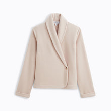 Load image into Gallery viewer, Sand. Soft fleece wrapover long sleeved bedjacket. It closes with a single Corozo button. The shawl collar and curved front detail add the final touches of style to this soft, light and cosy bedjacket. Made in Portugal. Available in Azur Blue Composition: 70% Polyester, 30% Viscose. Machine Washable.