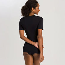 Load image into Gallery viewer, A woman wearing a black seamless cotton T-Shirt style top. It has a short sleeves and a V-Neck.
Image of the back.