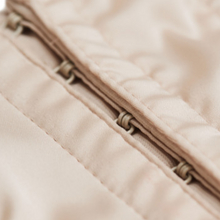 Load image into Gallery viewer, Nude. This is a beautiful, traditional corset made the French way. The Medici Corset is in a subtle soft satin. The front is boned for perfect shaping. The back has elastic panels with a hook & eye central opening, ensuring a perfect fit. The entire structure enhances the bust and highlights the waist. This is a stunning garment, meant for the wearer who wants to be noticed for their style and figure. It may be worn both as underwear and outerwear. Made in France.