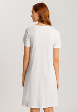 Load image into Gallery viewer, Soft White 100% soft mercerised knitted cotton. This is a lovely Short Sleeve V Neck nightgown. It has a lace inset on the neckline mirrored by a deep lace inset on the opposite hem. Light and airy to wear in bed. Deliciously comfortable for sleeping and lounging.
Length: 100cm
Composition: 100% Pure Cotton, 100% Polyester Lace.
Made in Europe
Machine washable
