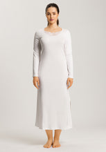 Load image into Gallery viewer, Soft White. Attractive 100% soft mercerised knitted cotton. This is a Long Sleeve full length nightgown with a gentle round neckline. It has a lace inset on the gently rounded neckline. There is also deep lace inset at the hem. The nightgown has side slits for ease of movement when sleeping. Light and airy to wear in bed. Deliciously comfortable for sleeping and lounging.
Length: 130cm
Composition: 100% Pure Cotton, 100% Polyester Lace.
Made in Europe
Machine washable