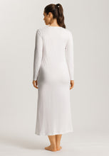 Load image into Gallery viewer, Soft White. Attractive 100% soft mercerised knitted cotton. This is a Long Sleeve full length nightgown with a gentle round neckline. It has a lace inset on the gently rounded neckline. There is also deep lace inset at the hem. The nightgown has side slits for ease of movement when sleeping. Light and airy to wear in bed. Deliciously comfortable for sleeping and lounging.
Length: 130cm
Composition: 100% Pure Cotton, 100% Polyester Lace.
Made in Europe
Machine washable