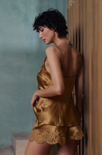 Load image into Gallery viewer, Caramel gold colour set.
This Marjolaine camisole and French knicker set is generously embellished with appliqué Calais lace. Camisole has spaghetti adjustable straps and the appliqué lace forms a sumptuous detail on the front, continuing down the front of the garment. The French Knickers have a sumptuous detail of appliqué lace on both hips. Its tone-on-tone Calais lace makes it a piece rich in luxurious details, while maintaining an airy yet comfy cut.