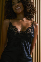 Load image into Gallery viewer, Black set.
This Marjolaine camisole and French knicker set is generously embellished with appliqué Calais lace. Camisole has spaghetti adjustable straps and the appliqué lace forms a sumptuous detail on the front, continuing down the front of the garment. The French Knickers have a sumptuous detail of appliqué lace on both hips. Its tone-on-tone Calais lace makes it a piece rich in luxurious details, while maintaining an airy yet comfy cut.