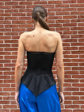 Load image into Gallery viewer, This is the most beautiful twill corset
Cadolle. The tailcoat detail accentuates the waist to perfection and can be worn as a statement top.
The structure flatters your shape and creates a beautiful bust. The zipper is placed on the back. Running along your hip is a wide band, flaring out in the back, just like a tail coat. Its design was inspired by conductors leading the orchestra.