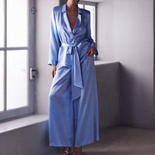 Load image into Gallery viewer, The Bea pyjamas embody a bold and contemporary elegance. Made of 100% heavy-weight silk, it plays on the contrasts between structure and fluidity, for a silhouette that is both assertive and comfortable.
The pants, flexible and fluid, have subtle pleating to create a beautiful volume with lightness. The elasticated waist at the back, guaranteeing a perfect fit.
The tailored jacket, draws a clean line thanks to its thin collar and integrated shoulder pads. Its wide belt emphasises the waist and structures
