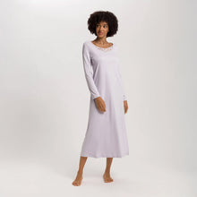 Load image into Gallery viewer, A woman wearing a Pink Lavender long sleeve full length (130cm) nightdress. It has a lovely round neckline embellished with a delicate embroidered lace trim on tulle. The garment has a lovely feminine flow to it with a slit on the side to allow for comfortable movement.
