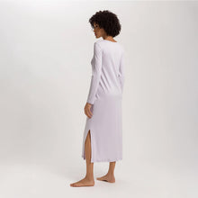 Load image into Gallery viewer, Image of the back of a woman wearing a Pink Lavender long sleeve full length nightdress. The garment has a lovely feminine flow to it and a slit on the side to allow for comfortable movement.