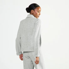 Load image into Gallery viewer, A woman shown from the back wearing a light gray cropped bed jacket against a plain white studio background.