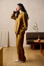 Load image into Gallery viewer, SALE 100% Pure Linen Pyjamas made by Luuna Mine; an artisan design studio based in Shanghai. The jacket has a shirt tail at the back, a gathered frilled cuff on the sleeve and signature moon embroidery detail on the classic collar. The trousers have two side pockets, a wide leg and an elasticated waist & French seams throughout. Perfect for sleeping and loungewear. Composition: 100% Linen. Machine washable. Sizing advice: These pyjamas come up small. If in doubt, select the bigger size.