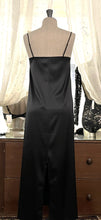 Load image into Gallery viewer, Black simple, plain & classic, full length silk satin nightgown. Made from 92% silk satin and with a little Elastane for stretch and movement. Adjustable spaghetti straps with a rounded neckline and all French seams for softness when wearing. The skirt is full length with a back slit. This garment is perfect for sleepwear or as a long slip under clothing. Generous sizing, if in doubt select the smaller size. Oscalito Silk is Certified GOTs Fabric Content: 92% Silk 8% Elastane