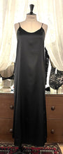 Load image into Gallery viewer, Black simple, plain & classic, full length silk satin nightgown. Made from 92% silk satin and with a little Elastane for stretch and movement. Adjustable spaghetti straps with a rounded neckline and all French seams for softness when wearing. The skirt is full length with a back slit. This garment is perfect for sleepwear or as a long slip under clothing. Generous sizing, if in doubt select the smaller size. Oscalito Silk is Certified GOTs Fabric Content: 92% Silk 8% Elastane