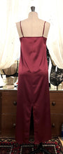 Load image into Gallery viewer, Burgundy simple, plain & classic, full length silk satin nightgown. Made from 92% silk satin and with a little Elastane for stretch and movement. Adjustable spaghetti straps with a rounded neckline and all French seams for softness when wearing. The skirt is full length with a back slit. This garment is perfect for sleepwear or as a long slip under clothing. Generous sizing, if in doubt select the smaller size. Oscalito Silk is Certified GOTs Fabric Content: 92% Silk 8% Elastane