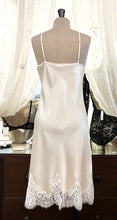 Load image into Gallery viewer, Butter/Ivory. Made in Italy, this is a beautiful long pure silk satin night/slip. There is stunning deep appliqué lace at the bust and hem. There are French seams throughout for softness. The fine spaghetti straps are adjustable for the perfect fit. This nightslip is cut on the bias and panelled giving lovely flare and movement. Perfect for bed or daywear. May be worn as underwear, nightwear or outerwear. Composition: 100% Silk Satin Italian Lace 100% polyamide Machine washable Length 82cm from nape.