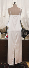 Load image into Gallery viewer, Ivory simple, plain & classic, full length silk satin nightgown. Made from 92% silk satin and with a little Elastane for stretch and movement. Adjustable spaghetti straps with a rounded neckline and all French seams for softness when wearing. The skirt is full length with a back slit. This garment is perfect for sleepwear or as a long slip under clothing. Generous sizing, if in doubt select the smaller size. Oscalito Silk is Certified GOTs Fabric Content: 92% Silk 8% Elastane