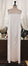 Load image into Gallery viewer, SALE Ivory simple, plain & classic, full length silk satin nightgown. Made from 92% silk satin and with a little Elastane for stretch and movement. Adjustable spaghetti straps with a rounded neckline and all French seams for softness when wearing. The skirt is full length with a back slit. This garment is perfect for sleepwear or as a long slip under clothing. Generous sizing, if in doubt select the smaller size. Oscalito Silk is Certified GOTs Fabric Content: 92% Silk 8% Elastane