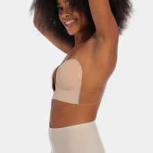 Load image into Gallery viewer, Woman wearing a beige strapless bra on a white background.
