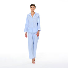 Load image into Gallery viewer, Blue & white stripe pure cotton pyjamas trimmed with 100% cotton lace. Front buttoned with a revere collar. Full length trouser with a soft elasticated waist. Perfect for sleeping or lounging.
Celestine garments are also addictive, so watch out. Once tried, there is no turning back! Celestine nightwear, dressing gowns, short robes and pyjamas drop from the shoulder, therefore one size fits all.
Fabric composition: 100% Cotton.
Made in Germany.
Machine Washable.