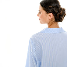 Load image into Gallery viewer, Blue & white stripe pure cotton pyjamas trimmed with 100% cotton lace. Front buttoned with a revere collar. Full length trouser with a soft elasticated waist. Perfect for sleeping or lounging.
Celestine garments are also addictive, so watch out. Once tried, there is no turning back! Celestine nightwear, dressing gowns, short robes and pyjamas drop from the shoulder, therefore one size fits all.
Fabric composition: 100% Cotton.
Made in Germany.
Machine Washable.