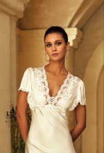 Load image into Gallery viewer, Made in France, a beautiful full length nightgown. It has a lovely lace festooned V neck and all lace short sleeves. Beautifully scooped back with lacing details. Its 92% and 8% spandex silk satin will delicately envelop the curves of the body giving a sensuous look and feel. Composition: Silk Satin 92%, 8% Spandex Care instructions: Machine or Hand wash in cold water. Length: 150cm approximately.