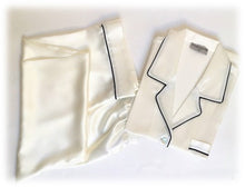 Load image into Gallery viewer, Our own classic pure silk 'men's style' pyjamas. They are made from 19 mm 100% pure heavyweight Silk Satin. One seam on the leg for extra comfort. Mother-of-pearl buttons, elastic waist the trousers. Perfect for sleeping and loungewear. Available in two colourways: Ivory/Navy Piping.