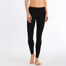 Load image into Gallery viewer, A woman wearing the black silk cashmere leggings. With a soft and wide elastic at the waist and soft trim around the ankle, these will provide the ultimate cosiness!
