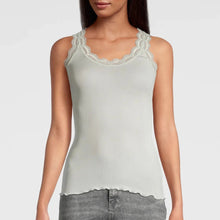 Load image into Gallery viewer, Ivory. Singlet style delicate fine ribbed knit fabric in pure silk organza with the most elegant and feminine French leavers lace and the neckline and shoulder. The lace is certified and numbered as true “Dentelle de Calais®”. Super-soft touch with no side seams, the construction is for the ultimate in comfort. Featuring a gently scooped neckline this singlet allows for a multiple of uses, as underwear or outerwear. 100% Silk All Oscalito Sik is certified GOTs. Machine washable
