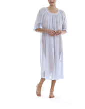 Load image into Gallery viewer, Azure Full length (123cm) 3/4 length sleeve nightgown. Gorgeous 100% Guipure Cotton Lace at the gently rounded neckline and a frilled detail at the sleeve hem. Flared skirt for ease of movement when sleeping. Made in Germany from the finest pure cotton mousseline, Celestine nightdresses are diaphanous, offering perfect sleep without heaviness.
Celestine nightwear, dressing gowns and short robes drop from the shoulder, therefore one size fits all.
100% Pure Swiss Cotton, 100% Guipure Cotton Lace.