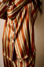 Load image into Gallery viewer, Heavy weight Stripe Silk Pyjamas made by Luuna Mine; an artisan design studio based in Shanghai. These are classic pure silk 'men's style' pyjamas They have contrasting blue piping on the cuff, ankle and jacket front. The collar is finished beautifully with a complementary gold silk. The pyjama print has a signature moon detail on the stripe. They are made 100% pure heavyweight Silk Satin. They have elasticated and a drawstring waist & French seams throughout.