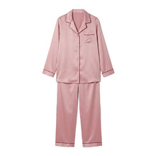 Load image into Gallery viewer, Luxury blush pink silk satin pyjama set featuring a long-sleeved button-front shirt, burgundy contrast piping and matching full-length trousers.