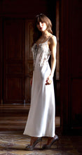 Load image into Gallery viewer, Ivory/Granite. Made in France, a beautiful nightgown made from 100% silk satin. Full length with heavily appliquéd Calais lace detail on the bodice. The straps have an adjustment for creating the perfect fit. Luxurious, elegant nightwear.
Composition: 100% Silk Satin
Calais Lace 75% Cotton, 25% Nylon
Care instructions:
Machine or Hand wash in cold water.