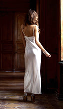 Load image into Gallery viewer, Ivory/Granite. Made in France, a beautiful nightgown made from 100% silk satin. Full length with heavily appliquéd Calais lace detail on the bodice. The straps have an adjustment for creating the perfect fit. Luxurious, elegant nightwear.
Composition: 100% Silk Satin
Calais Lace 75% Cotton, 25% Nylon
Care instructions:
Machine or Hand wash in cold water.