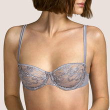Load image into Gallery viewer, This is a perfect balconnet bra. The horizontal seam blends attractively with the embroidery, forming a beautifully shaped cup. The double satin spaghetti straps create delicacy with strength. Andres Sarda is famous for its innovation in its use of fabrics. Tina in Metallic Silver is a perfect example. Fabric Content: Polyester: 50%, Polyamide: 44%, Elastane: 6%