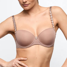 Load image into Gallery viewer, Woman wearing a beige bra with decorative straps on a light gray background