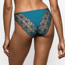 Load image into Gallery viewer, Rear view of a model wearing teal blue lace panties with a solid teal blue waistband, set against a plain light gray studio background.