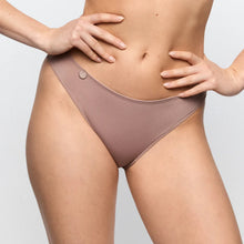 Load image into Gallery viewer, Person wearing a pair of brown underwear on a light gray background