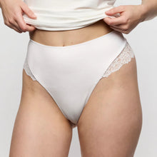 Load image into Gallery viewer, White lace underwear being worn against a plain background