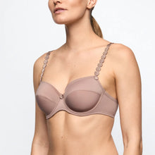 Load image into Gallery viewer, Woman wearing a beige bra with decorative straps on a light gray background