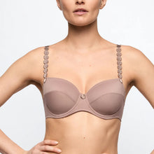 Load image into Gallery viewer, Woman wearing a beige bra with decorative straps on a light gray background